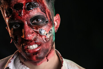 Scary zombie on dark background