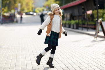 cute girl dressed in autumn clothes on a walk