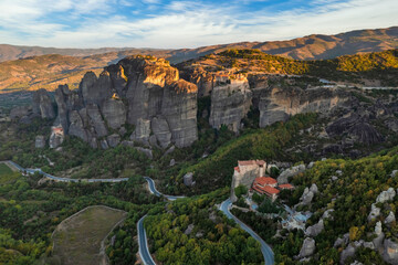 Mountain monastery and rocks in Meteora at sunset. Greece.