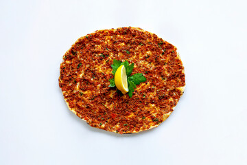 Turkish Lahmacun and a slice of lemon.
