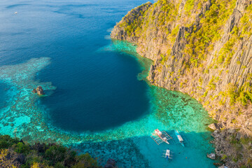 Aerial view of turquoise tropical lagoon with limestone cliffs in Coron Island, Palawan, Philippines. UNESCO World Heritage.