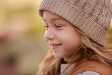 cute girl dressed in autumn clothes on a walk