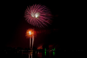 Fireworks with beautiful colorful flowers on a dark sky background.