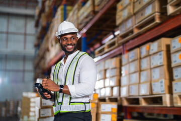 Warehouse worker working process checking the package with a barcode scanner in a large...