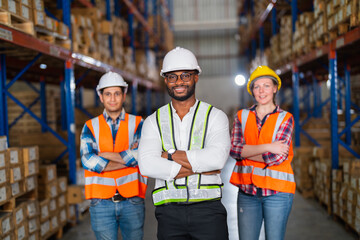 A small group of warehouse workers standing in a large distribution center. concept of teamwork and occupation.