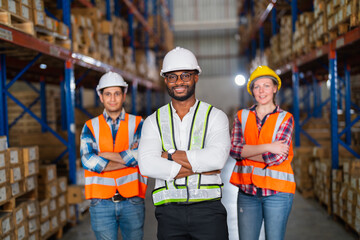 A small group of warehouse workers standing in a large distribution center. concept of teamwork and occupation.