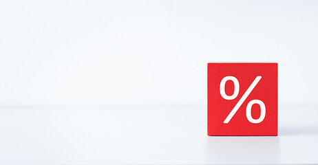 red cube with percent sign on light background, discount and sale concept