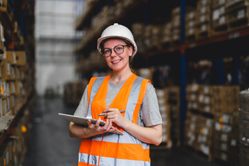 Portrait of a warehouse worker standing in a distribution center. Caucasian female looking at camera. concept of occupation and career.