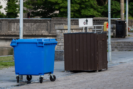 Three type of waste bins in town. Temporary big blue on wheels. Big size permanent decorated bin and small permanent. Waste and recycle industry. Clean town concept