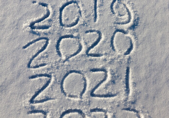 the inscription about the new year 2022 on the snow in winter