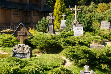 Old cemetery in front of Medieval Norwegian stave wooden church Vang or Wang in Karpacz, Poland