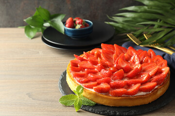 Concept of tasty food with strawberry tart on wooden table