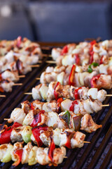 Grilled kebab cooking on metal skewer. Roasted meat cooked at barbecue. BBQ fresh beef meat chop slices. Traditional eastern dish, shish kebab. Grill on charcoal and flame, picnic, street food