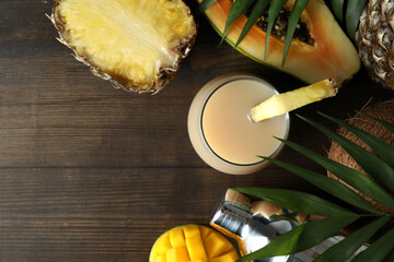Pina colada cocktail and ingredients on wooden table