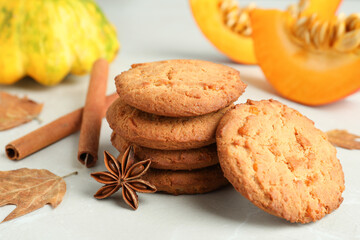 Pumpkin cookies on white textured background, close up