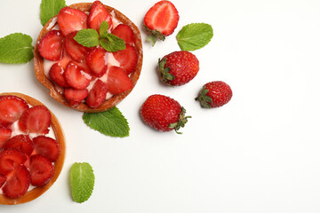 Delicious strawberry tarts on white background, space for text