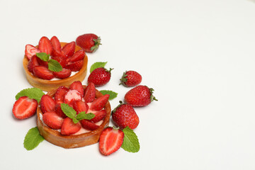Delicious strawberry tarts on white background, space for text