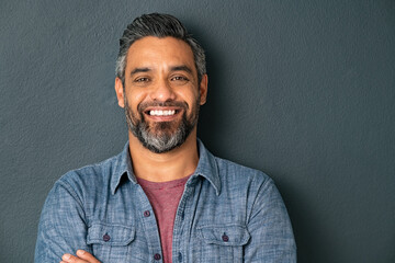 Portrait of successful middle eastern man isolated on grey wall