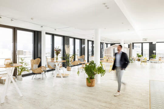 Male business professional walking in office