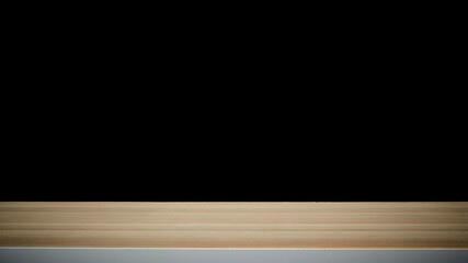 empty wooden table on dark background