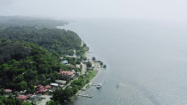 Aerial view Roatan Honduras. the Caribbean coast with waves crashing against the sandy beaches and jungle in the mountains of the island.
