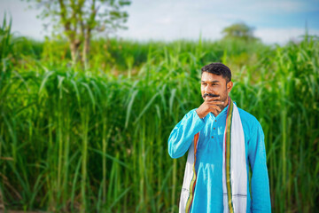 Indian farmer feeling happy and proud in sugarcane field