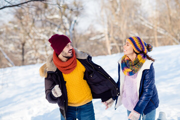 Photo of attractive young couple happy positive smile go walk run park hold hands together weekend winter snow