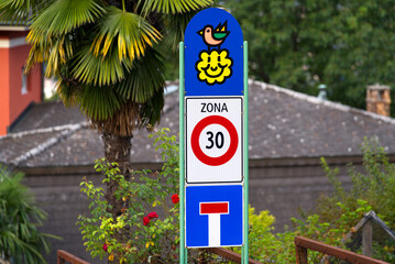 Traffic sign speed limit and zone 30 kilometer per hours at City of Lugano on a cloudy late summer morning. Photo taken September 11th, 2021, Lugano, Switzerland.