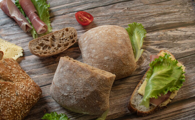Bread, fresh baked goods and herbs, ham rolls