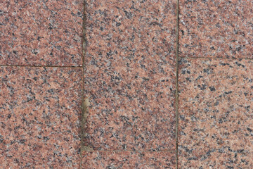 Brown-red granite pavement. Pavement texture background. 
