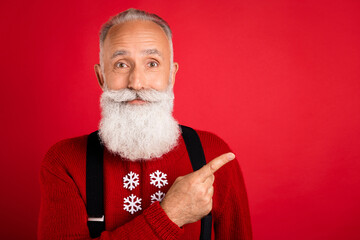 Photo of aged man happy positive smile point finger empty space ad promo sale holiday isolated over red color background