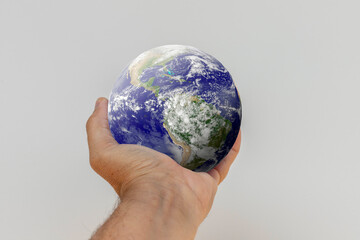 Planet Earth in the palm. Elements of this image provided by NASA