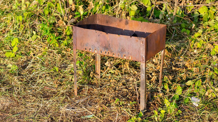 old barbecue is abandoned on the bank of the river