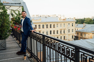 Male professional standing near railing in office balcony