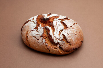 Freshly baked sourdough bread, homemade. Healthy yeast-free bread on brown background
