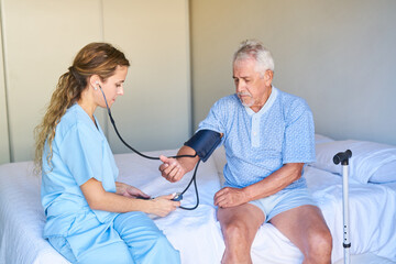 Nurse measuring senior's blood pressure