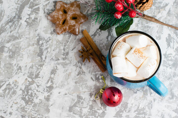 Fototapeta na wymiar Delicious cocoa with cinnamon and marshmallows, christmas decor and gingerbread on a light table top, flatlay, copy space
