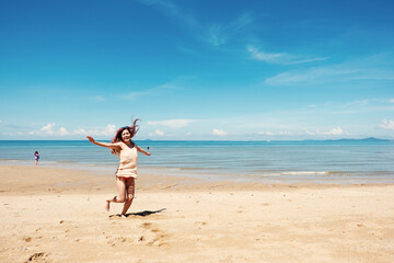 attractive woman on beach. Summer holiday fashion concept woman wearing sun hat at the beach on sand shot from above Happiness sexy girl at sunset time. summrer travel or vacation concept.
