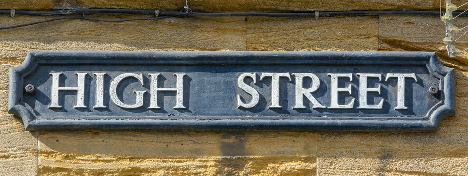 High Street name sign, close up of old style of English street plaque, shallow depth of field, autumn season 2021