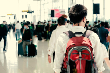 asian Man holding passport wearing a mask for prevent virus in international airport waiting for flight aircraft. Protection against Coronavirus	