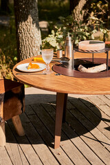 Kettle Grill Pit with Cast Iron Grid with flames . Round table-cooking surface. Hot BBQ on Backyard