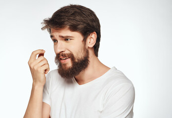 emotional man in a white t-shirt irritated facial expression close-up