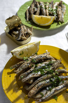 Grilled fish served on plate with lemon and herbs