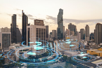 Glowing hologram of technological process, aerial panoramic cityscape of Bangkok at sunset. The largest innovative hub of tech services in Southeast Asia. Multi exposure.