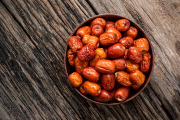 Obraz premium Dried jujube fruits on an old wood background.top view,flat lay.