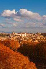 Fototapeta na wymiar Autumn in Rome. View of the historical center skyline with Quirinal Hill and red leaves
