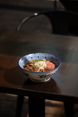 Japanese kumamoto shio ramen with horse meat on restaurant table