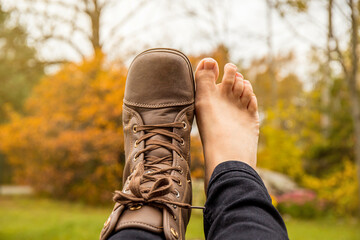 Person wearing barefoot boots shoes, which are wide, comfortable and healthy concept. Wide toebox fits all toes without compressing them together helps keep right body posture.