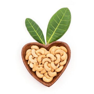 Dried cashew nuts fruits and green leaves isolated on background with clipping path.top view ,flat lay.