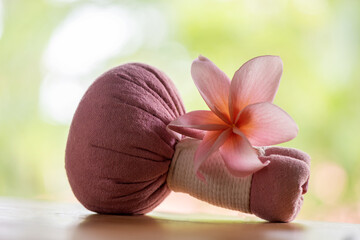 Aromatherapy with plumeria flower and herbal ball on nature background.